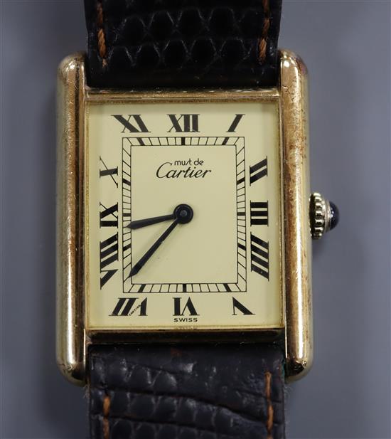 A ladys silver gilt Must de Cartier manual wind rectangular wrist watch, with Roman dial,